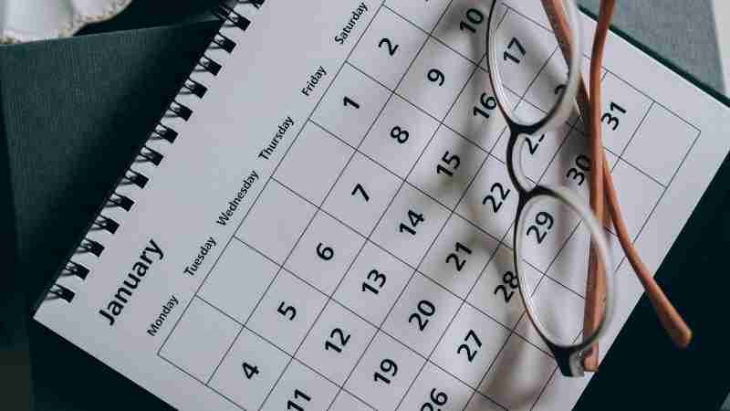 A close-up of a January calendar with eyeglasses on a table, emphasizing planning and organization., tags: 2026 mit - pexel